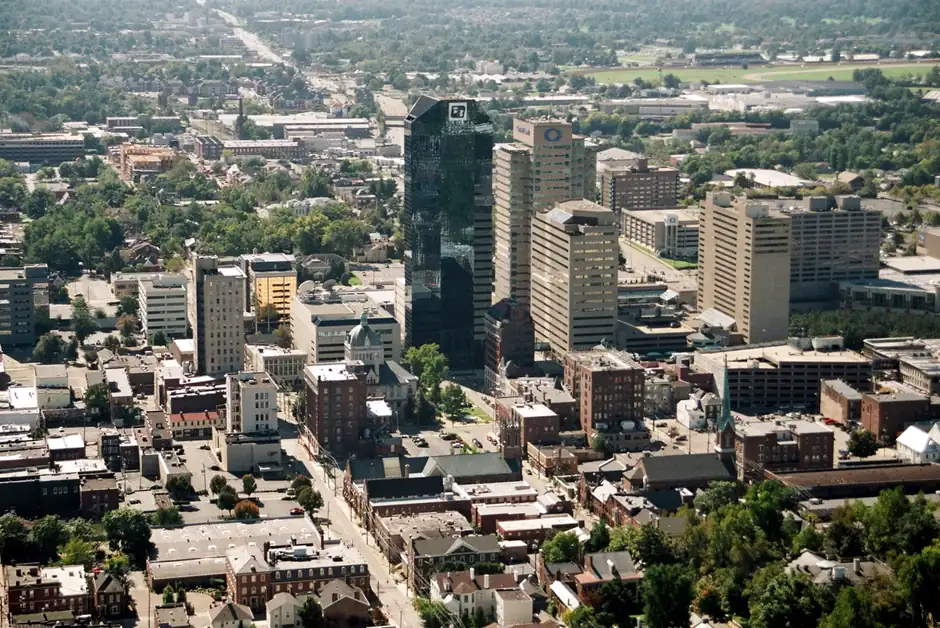 Downtown Lexington, Kentucky from above: the dark glass Lexington Financial Center beside the Central Bank tower, with brick blocks and tree-lined streets around them.