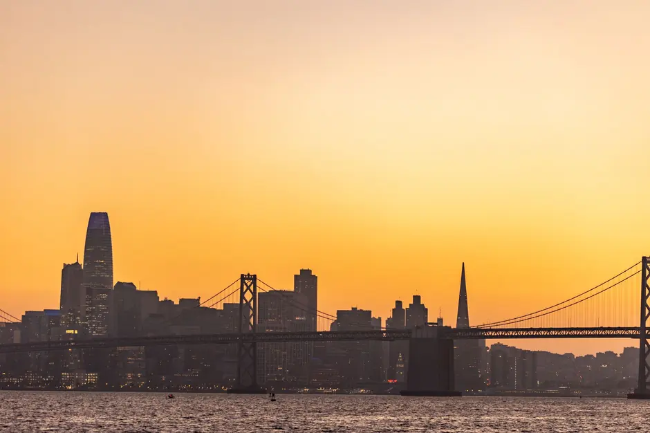 A captivating view of the San Francisco skyline and Bay Bridge during sunset, showcasing colorful skies.